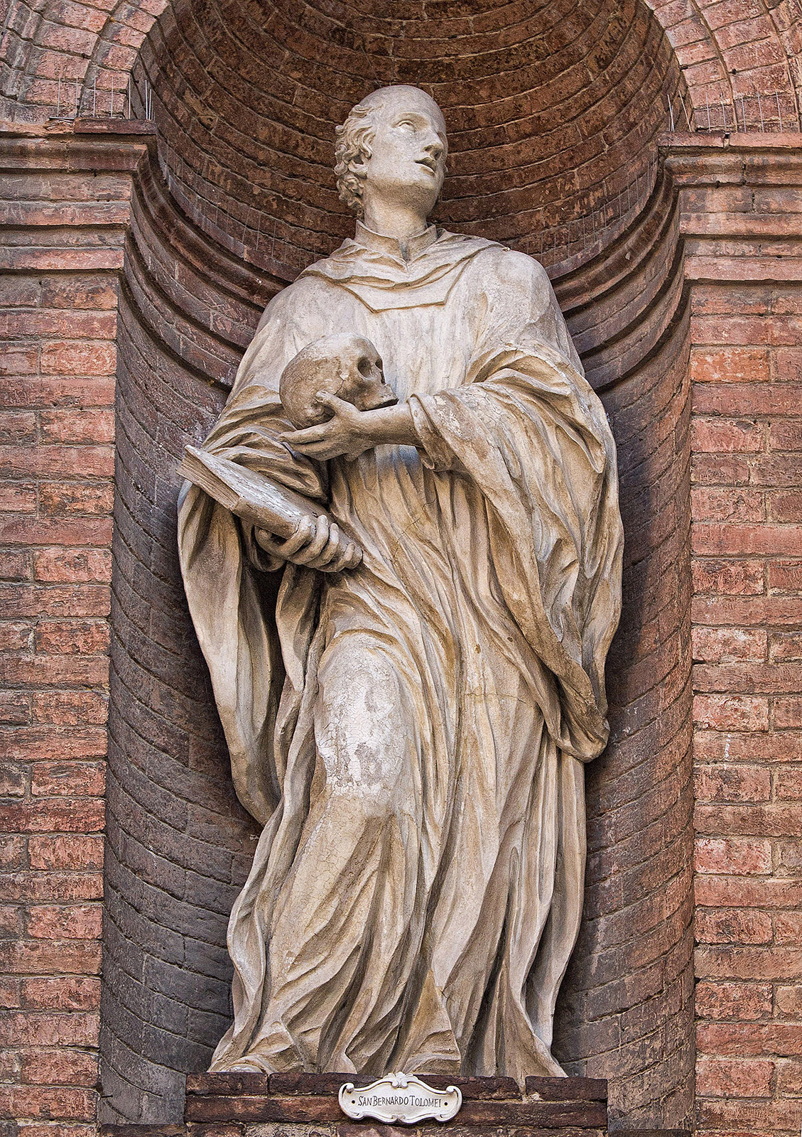 A statue of San Bernardo Tolomei on the Chiesa di San Cristoforo in the Piazza Tolomei, Siena Italy.