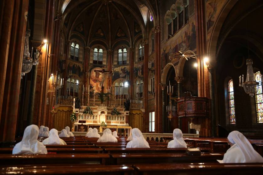 The Sisters of St. Joseph Cottolengo pray before the blessed sacrament inside the Chiesa Piccola.jpg