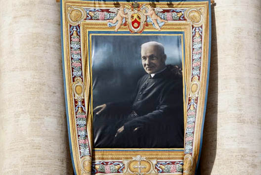 A tapestry showing new Canadian Saint Andre Bessette hangs from Saint Peter's Basilica as Pope Benedict XVI leads a solemn mass in Saint Peter's square